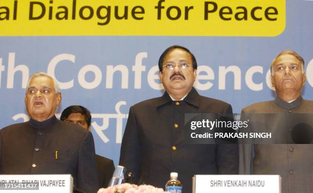 Indian Prime Minister Atal Behari Vajpayee sings a patriotic song with Bhartiya Janata Party President Venkaih Naidu and Foreign Minister Yashwant...