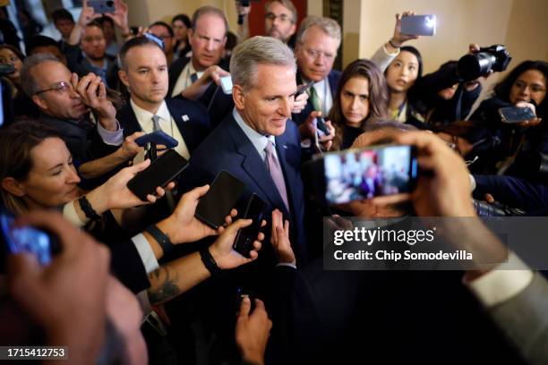 Speaker of the House Kevin McCarthy is surrounded by staff, security and journalists as he walks to the House Chamber ahead of a vote at the U.S....