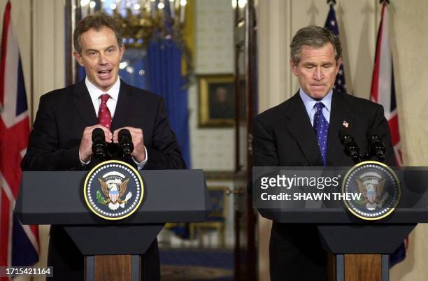 President George W. Bush and British Prime Minister Tony Blair answer questions 31 January 2003 during a joint press conference in the Grand Foyer of...