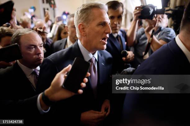 Speaker of the House Kevin McCarthy is surrounded by staff, security and journalists as he walks to the House Chamber ahead of a vote at the U.S....