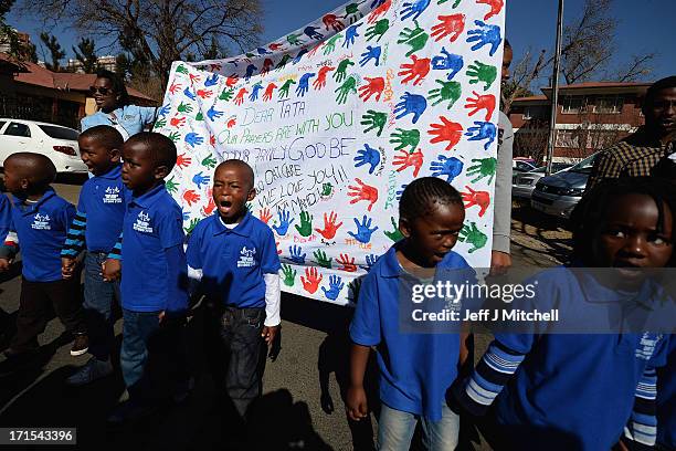 Children gather to leave messages of support for former South African President Nelson Mandela outside the Mediclinic Heart Hospital June 26, 2013 in...