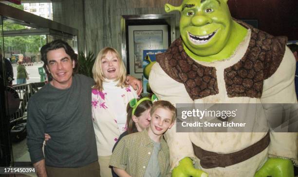 View of married couple, actor Peter Gallagher and Paula Harwood, with their children Kathryn and James Gallagher, as they pose with a costumed...