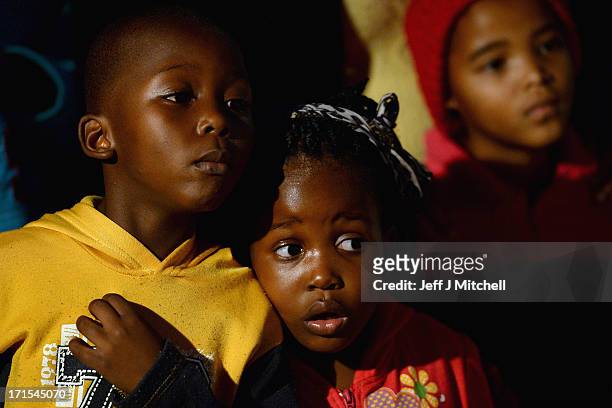Children gather to leave messages of support for former South African President Nelson Mandela outside the Mediclinic Heart Hospital June 26, 2013 in...