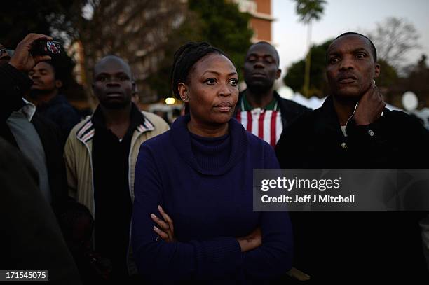 People gather to leave messages of support for former South African President Nelson Mandela outside the Mediclinic Heart Hospital June 26, 2013 in...