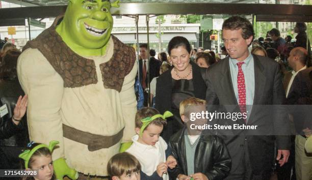 View of married American couple, architect Mary Richardson Kennedy and attorney Robert F Kennedy Jr, along with several children and a costumed...