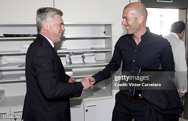 Carlo Ancelotti greets Zinedine Zidane at Ciudad Real Madrid on Valdebebas on June 26, 2013 in Madrid, Spain.