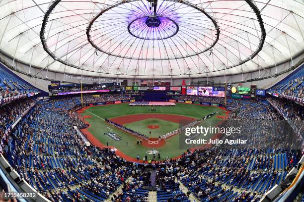 The Tampa Bay Rays and the Texas Rangers line up for the national anthem prior to the start of Game One of the Wild Card Series at Tropicana Field on...