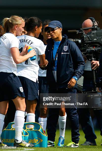 Manager Hope Powell of England shakes hands with her player Rachel Yankey after the International friendly match between England and Japan at the...