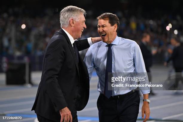 Carlo Ancelotti, Head Coach of Real Madrid, interacts with Rudi Garcia, Head Coach of Napoli, prior to the UEFA Champions League match between SSC...