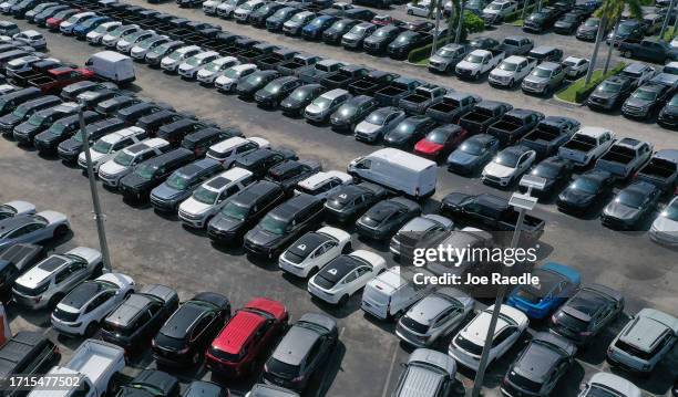 New vehicles sit on a Ford dealership's lot on October 03, 2023 in Miami, Florida. U.S. Automakers show a rise in sales in the third quarter even...