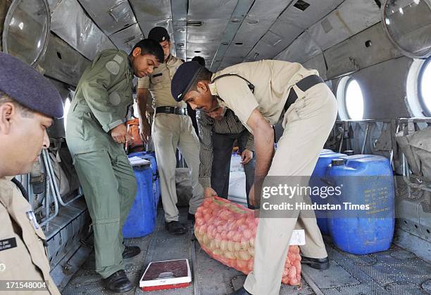 Relief material for those stranded in disaster affected areas being loaded in a helicopter at the Jolly Grant airport on June 26, 2013 in Dehradun,...