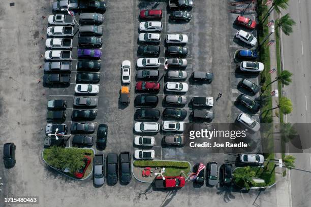 In an aerial view, new vehicles sit on a Dodge Chrysler-Jeep Ram dealership's lot on October 03, 2023 in Miami, Florida. U.S. Automakers show a rise...