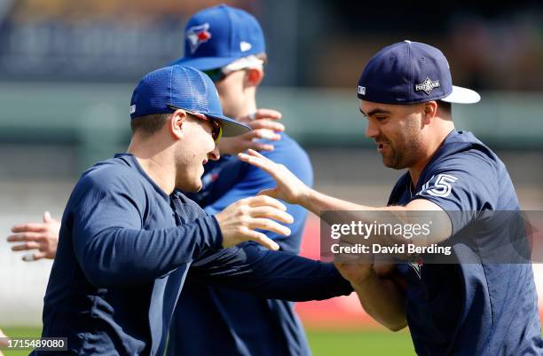 Daulton Varsho and Whit Merrifield of the Toronto Blue Jays joke around prior to Game One of the Wild Card Series against the Minnesota Twins at...