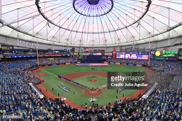 The Tampa Bay Rays and the Texas Rangers line up for the national anthem prior to the start of Game One of the Wild Card Series at Tropicana Field on...