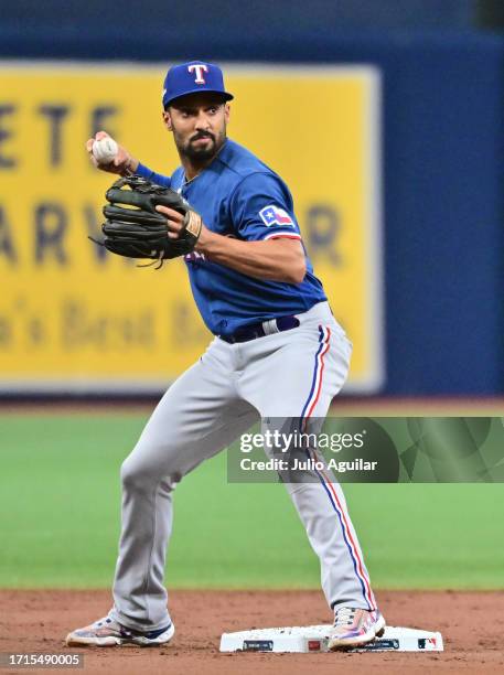 Marcus Semien of the Texas Rangers throws to first base in the first inning against the Tampa Bay Rays during Game One of the Wild Card Series at...