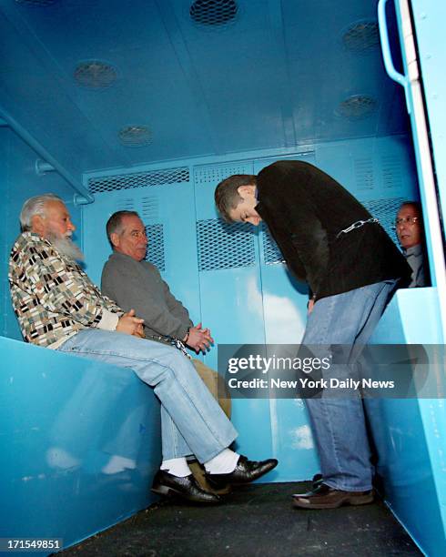 Charles Carneglia, Joseph Corozzo and Frank Cali sit inside a police paddywagon outside the FBI's New York Field Office at 26 Federal Plaza, after...