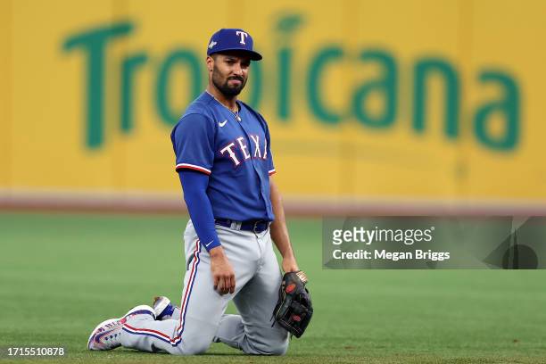 Marcus Semien of the Texas Rangers reacts after almost colliding with teammate Corey Seager during Game One of the Wild Card Series against the Tampa...