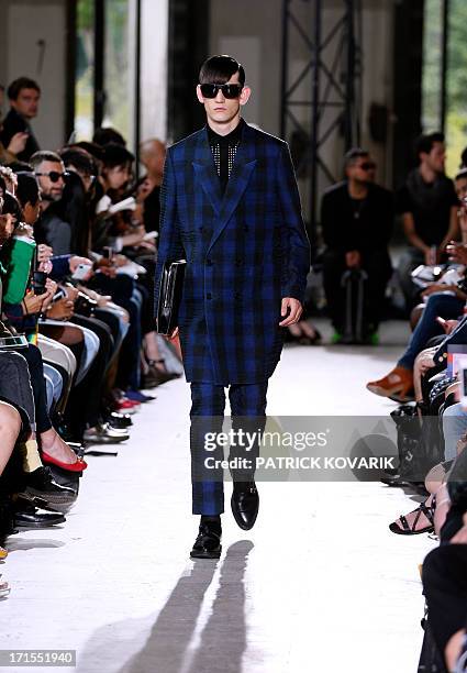 Model presents a creation by Arashi Yanagawa for John Lawrence Sullivan fashion house during the men's spring/summer 2014 ready-to-wear fashion show...