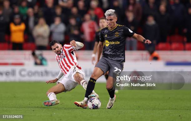 Carlos Alcaraz of Southampton runs past Mehdi Leris of Stoke City during the Sky Bet Championship match between Stoke City and Southampton FC at...