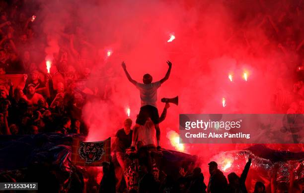 Fans set off flares during the UEFA Champions League match between RC Lens and Arsenal FC at Stade Bollaert-Delelis on October 03, 2023 in Lens,...