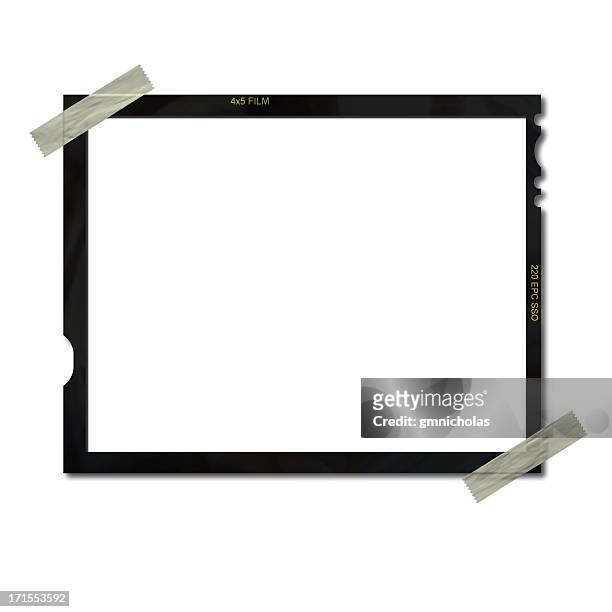 empty film frame taped on upper left and lower right corners - fotorolletje stockfoto's en -beelden