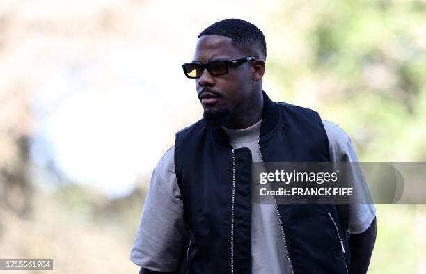 France's goalkeeper Mike Maignan arrives for a training session in Clairefontaine-en-Yvelines on October 9, 2023 as part of the team's preparation...