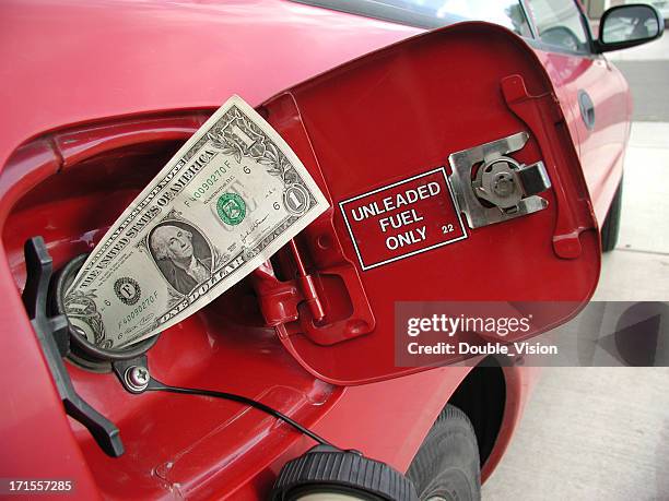 gas prices concept: dollar bill sticking out of gas tank - high sticking stock pictures, royalty-free photos & images