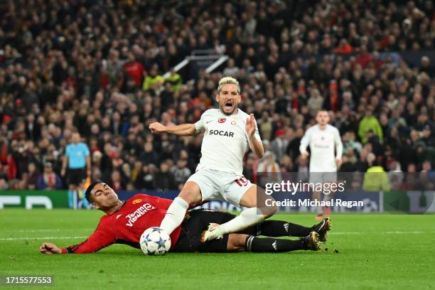 Casemiro of Manchester United fouls Dries Mertens of Galatasaray S.k during the UEFA Champions League match between Manchester United and Galatasaray...