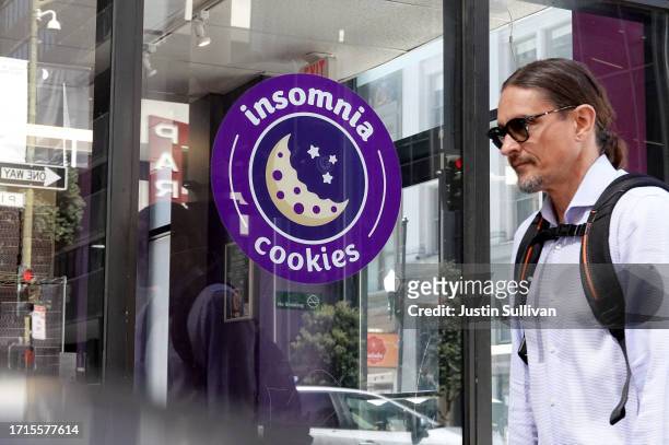 Pedestrian walks by an Insomnia Cookies store on October 03, 2023 in San Francisco, California. Doughnut company Krispy Kreme is looking to sell its...