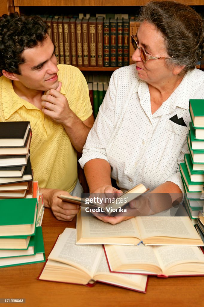 Student and teacher with lots of books