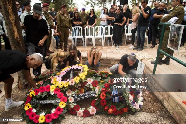 Family and friends of fallen IDF soldier Afik Rozental, who died in a battle with Hamas militants, attend his funeral on October 9, 2023 in Kfar...