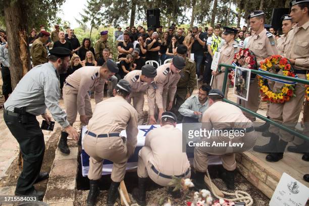 Family and friends of fallen IDF soldier Afik Rozental, who died in a battle with Hamas militants, react during his funeral on October 9, 2023 in...