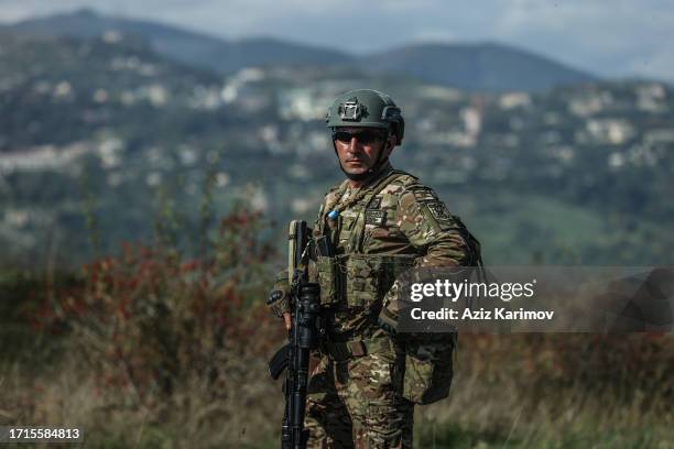 An Azeri serviceman stands at a former Armenian separatists military position in the village of Mukhtar retaken recently by Azeri troops, during an...