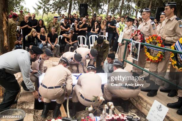 Family and friends of fallen IDF soldier Afik Rozental, who died in a battle with Hamas militants, react during his funeral on October 9, 2023 in...