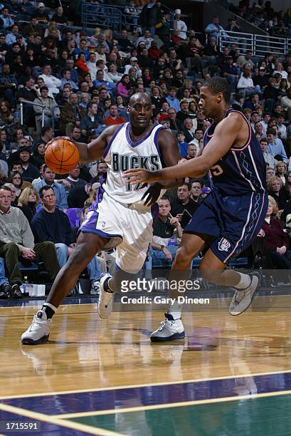 Anthony Mason of the Milwaukee Bucks is defended by Jason Collins of the New Jersey Nets during the game at Bradley Center on December 28, 2002 in...
