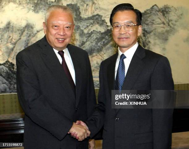 Chinese Premier Wen Jiabao shakes hands with Hong Kong Chief Executive Tung Chee-hwa prior to a meeting at Zhongnanhai, the Chinese leadership...