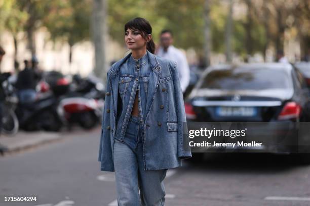 Kelly Piquet is seen outside Zimmermann show wearing a full denim look with blazer, jacket and pants and yellow snake print heels during the...