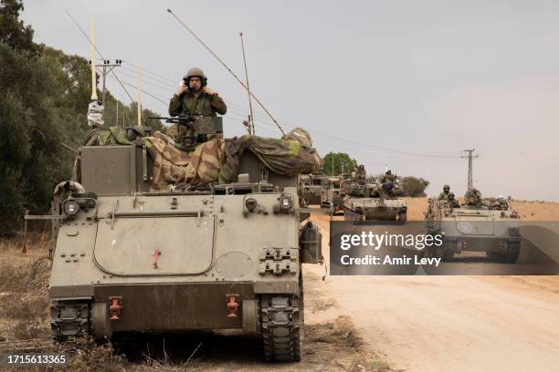 Israeli armored personnel carriers drive toward the Israeli southern border with the Gaza Strip on October 9, 2023 near Sderot, Israel. On October 7,...