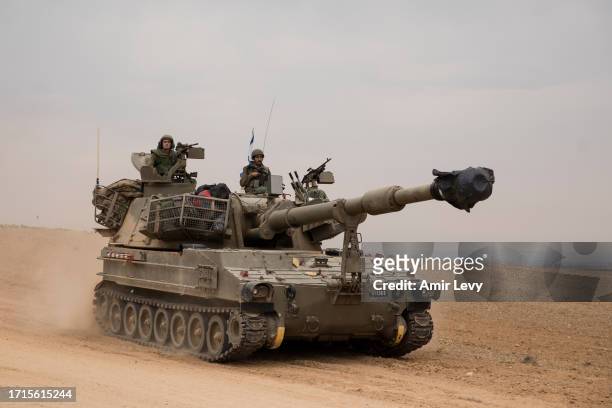 An Israeli tank drives toward the Israeli southern border with the Gaza Strip on October 9, 2023 near Sderot, Israel. On October 7, the Palestinian...