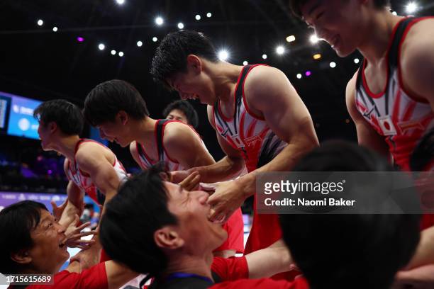 Members of Team Japan celebrate during the Men's Team Final on Day Four of the 2023 Artistic Gymnastics World Championships on October 03, 2023 in...
