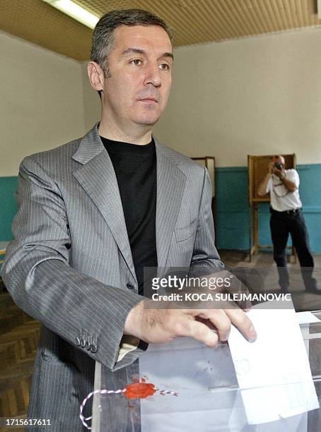 Montenegrin Prime Minister and former President Milo Djukanovic casts his ballot at a polling station in Podgorica, 11 May 2003. Montenegro went to...