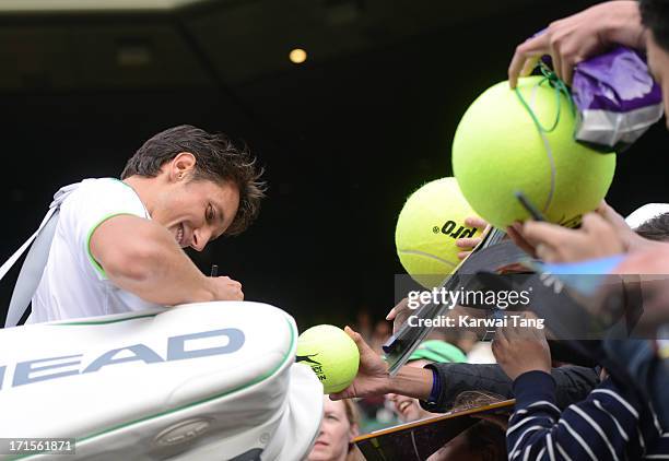 Sergiy Stakhovsky signs autographs for the fans on Day 3 of the Wimbledon Tennis Championships 2013 at Wimbledon on June 26, 2013 in London, England.