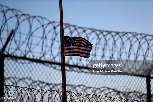 An American flag flies over Camp VI at the U.S. Military prison for 'enemy combatants' on June 26, 2013 in Guantanamo Bay, Cuba. President Barack...