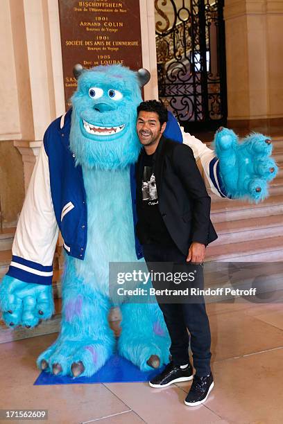 Humorist Jamel Debbouze poses at 'Monsters University' Paris movie premiere, held at La Sorbonne on June 26, 2013 in Paris, France.