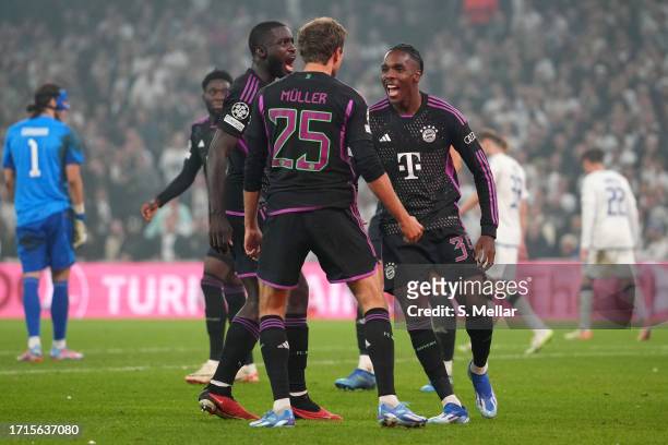 Mathys Tel of Bayern Munich celebrates with teammates Dayot Upamecano and Thomas Mueller after scoring the team's second goal during the UEFA...