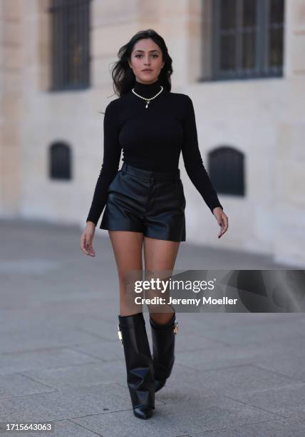 Agustina Walker Castro-Rioseco is seen wearing pearl earrings and a pearl necklace with golden pendant from Vivienne Westwood; a black, long-sleeved,...