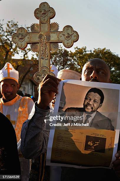 People gather to leave messages of support for former South African President Nelson Mandela outside the Mediclinic Heart Hospital June 26, 2013 in...