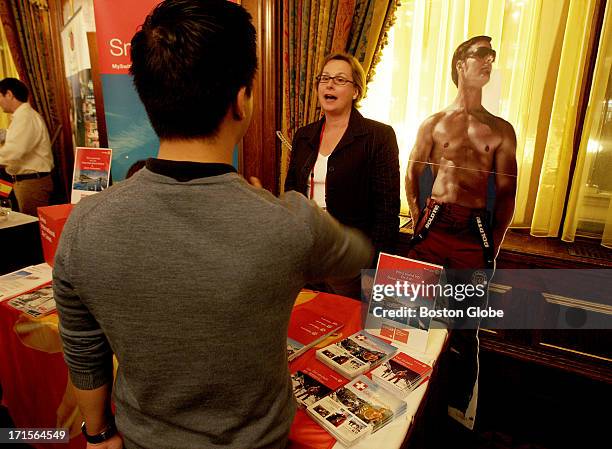 Jonathan Tranpham of Hanover, NH, speaks to Erika E. Loser, with Switzerland Tourism, as she and other presenters took part in the Gay and Lesbian...