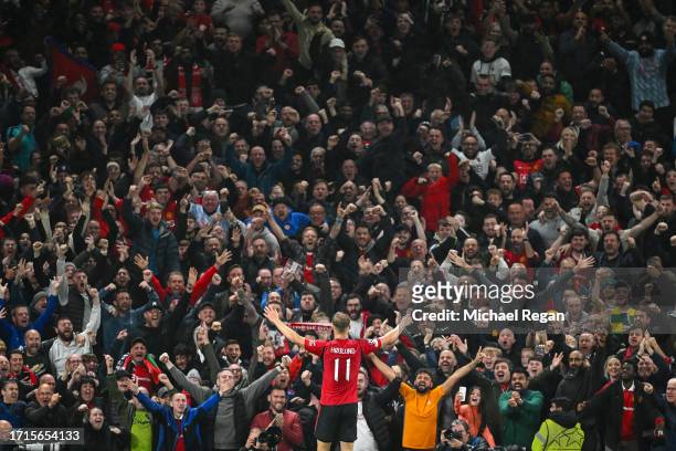 Rasmus Hojlund of Manchester United celebrates with fans after scoring the team's second goal during the UEFA Champions League match between...