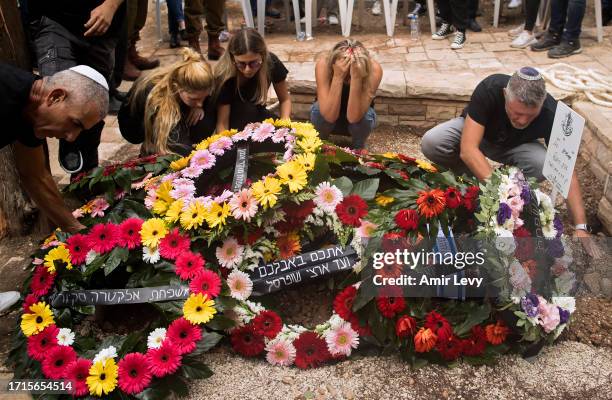 Family and friends of fallen IDF soldier Afik Rozental, who died in a battle with Hamas militants, attend his funeral on October 9, 2023 in Kfar...